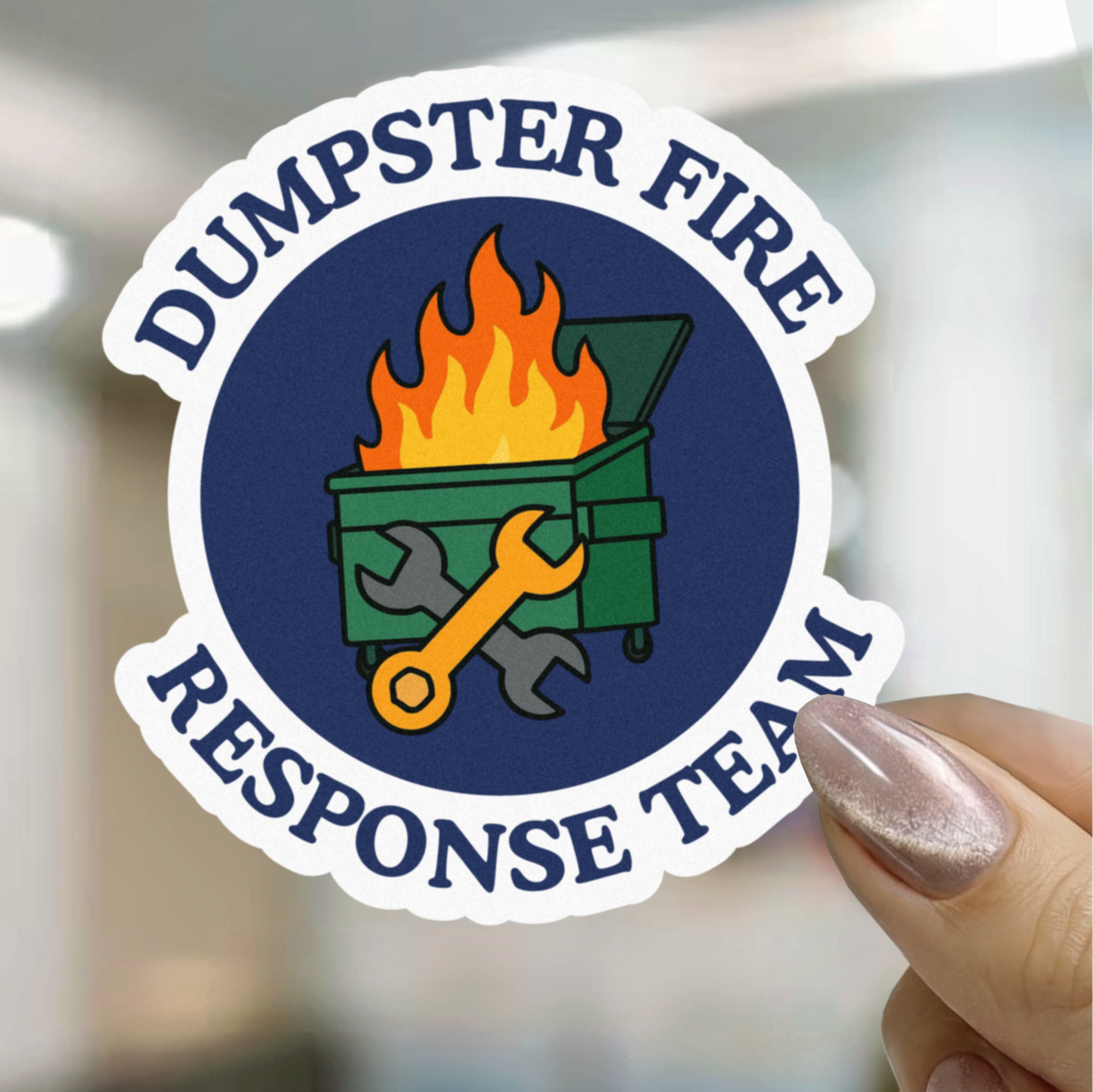 Sticker with 'Dumpster Fire Response Team' design held by a hand.