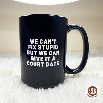 We Can't Fix Stupid But We Can Give It A Court Date Black Mug