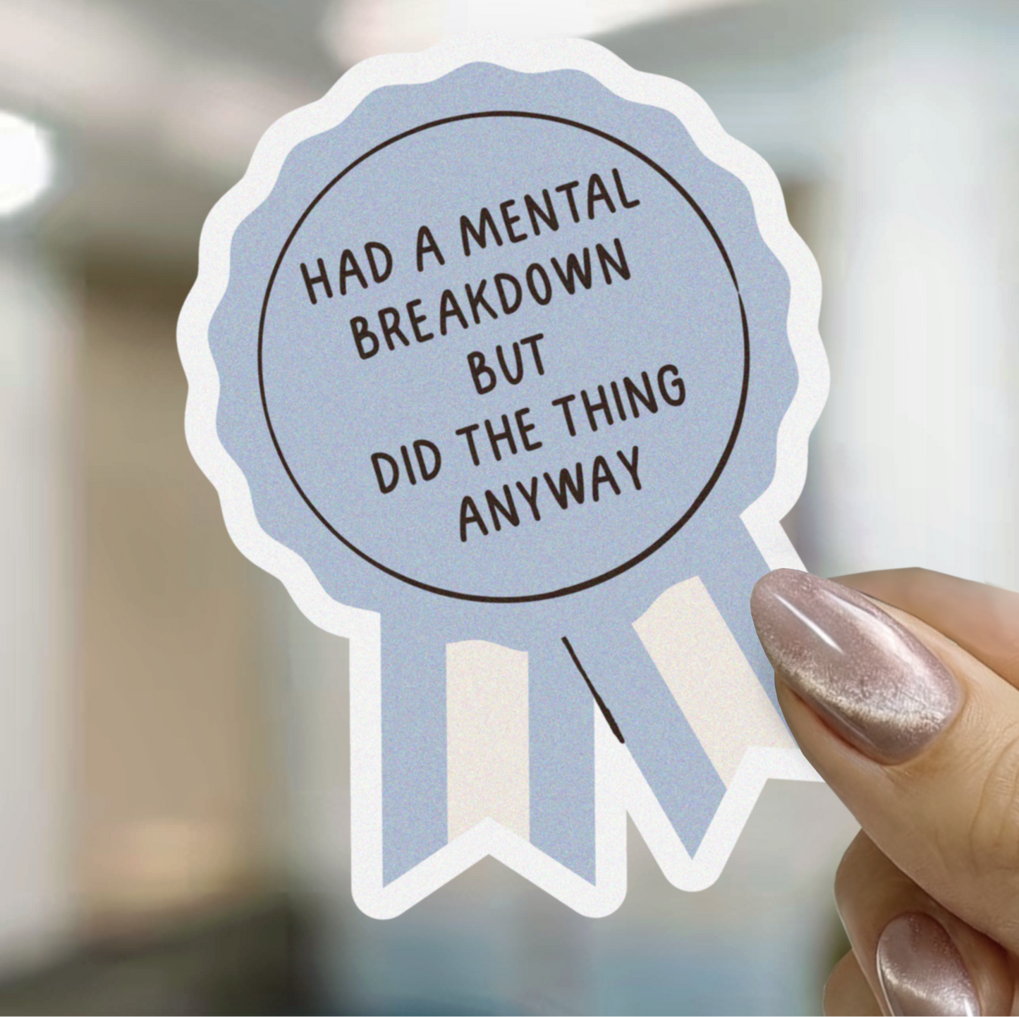 Sticker with text 'Had a mental breakdown but did the thing anyway' held by a hand.