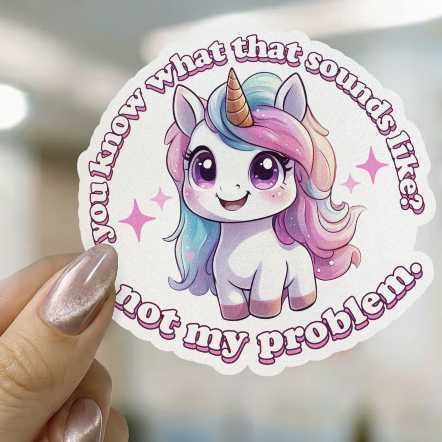 Sticker with a unicorn illustration and text held by a hand